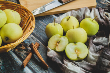 green apples on a dark background, cinnamon