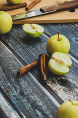 green apples on a dark background, cinnamon