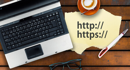 Paper width http and https and laptop on wooden table