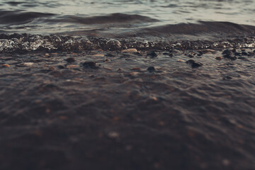 Close-up of water texture, smooth waves of water on the shore, landscape photo of water .  Calm...