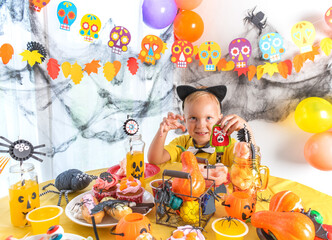 Happy family preparing for Halloween. Boy wearing a black cat suit.