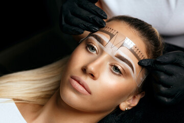 Measuring with ruler for brow tattoo - obrazy, fototapety, plakaty
