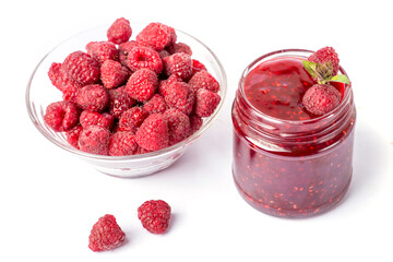 raspberry jam in a glass jar and raspberry berries on a