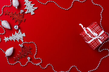 Red background with carved wooden Christmas trees
