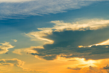 Golden sunset sky. Heaven sky. Blue and yellow sky with white cloud. Golden sun light at dusk. Beauty in nature. Beautiful natural pattern of golden sunset sky. Dusk and dawn times abstract background