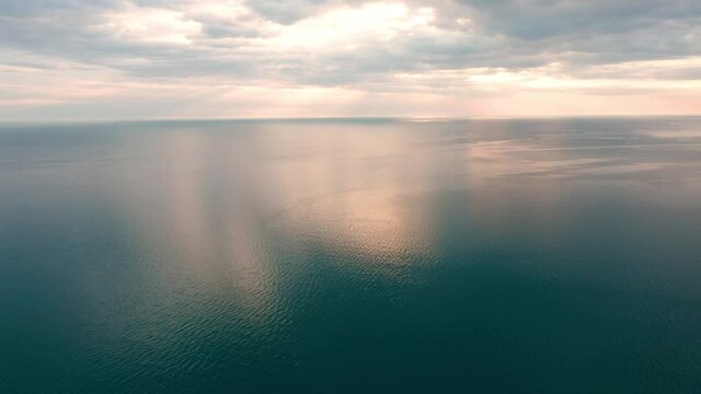 Aerial video over the morning calm sea and beautiful sunrise - Black Sea, Bulgaria