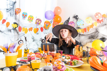 Dressed in spooky halloween costumes girl headwear having video chat on laptop with friends in...