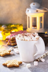Christmas background. A cup of hot cocoa with marshmallows and Christmas baking on a stone countertop.  Copy space.