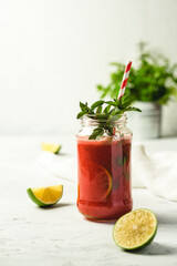 A photo with a smoothie with lime and strawberry
