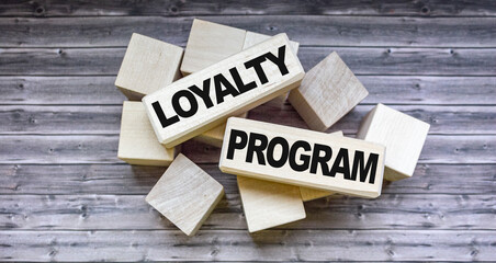 Loyalty program text on wooden blocks and on brown table