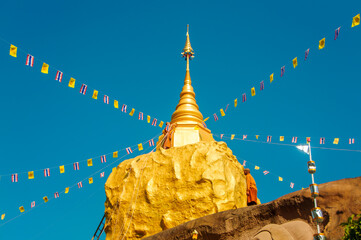 Sculpture,Golden pagoda ,Carved stone at Sakon Nakhon, Thailand.