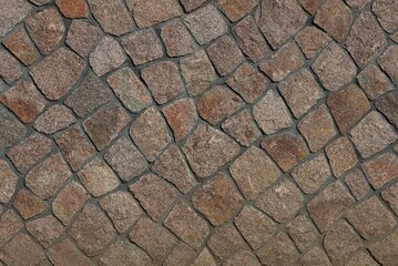 Obraz premium brown stone texture of small cobblestones in the wall of the fence
