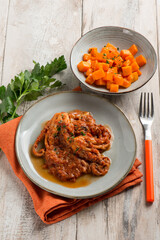 baby octopus with tomato sauce and pumpkin salad