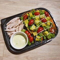 Green vegan salad from green leaves mix and vegetables. eat clean  for heaalthy.Top view on gray stone table.