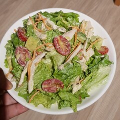 Green vegan salad from green leaves mix and vegetables. eat clean  for heaalthy.Top view on gray stone table.