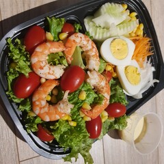 Green vegan salad from green leaves mix and vegetables. eat clean  for heaalthy.Top view on gray stone table.