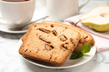 Slices of pear bread on white marble table, closeup. Homemade cake