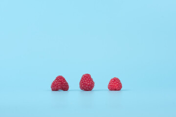 Raspberries on a Blue Background