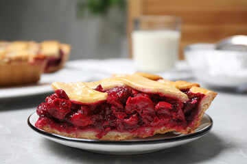 Piece of delicious fresh cherry pie on light grey marble table, closeup