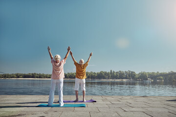 Sporty couple practicing yoga in the morning