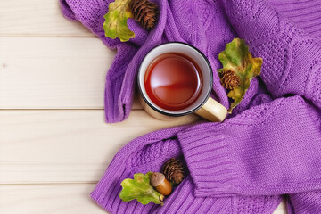 autumn flat lay purple sweater, metal tea mug with oak leaves and pine cones