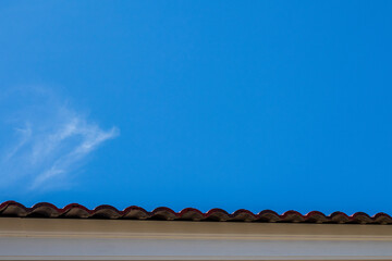 Gray tile roof of construction house with blue sky.