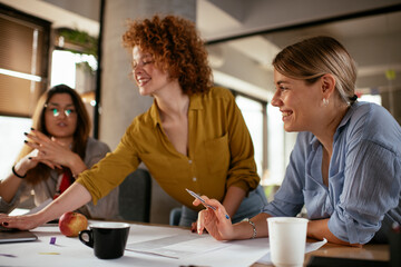 Businesswomen working on a new project. Colleagues discussing about problem they have to solved.