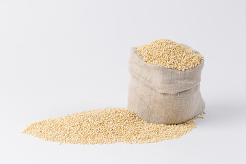 Quinoa groats in sack on black background