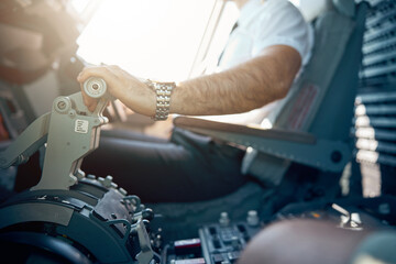 Side view of male hand on the throttle of civil passenger airplane