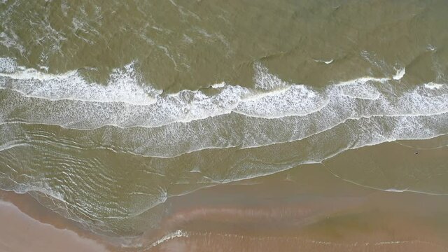 Aerial view of sea waves and sandy beach above the beach of zandvoort netherlands