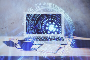 Double exposure of desktop computer and technology theme hologram. Concept of software development.