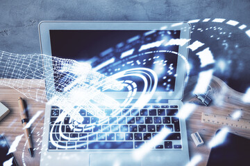 Double exposure of desktop computer and technology theme hologram. Concept of software development.