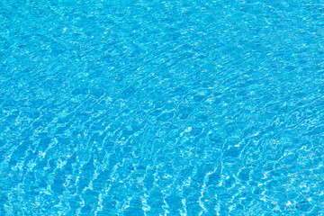 background of reflecting water inof a pool with blue tiles