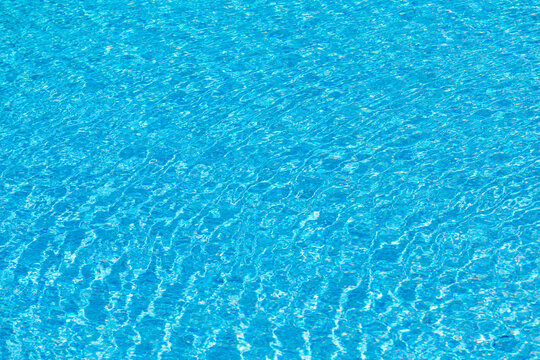 background of reflecting water inof a pool with blue tiles