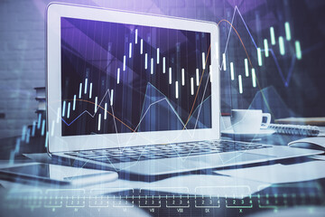 Financial graph colorful drawing and table with computer on background. Multi exposure. Concept of...