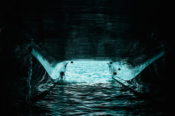 Underside of a double hull passenger boat, water reflecting off the painted hull. Canal of light...