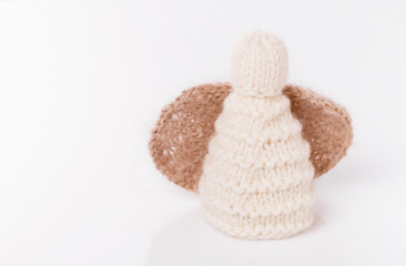 White crocheted Christmas angel on a white background