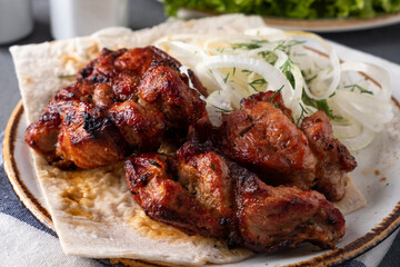 Bbq pork meat pieces on a plate. Shish kebab. Closeup