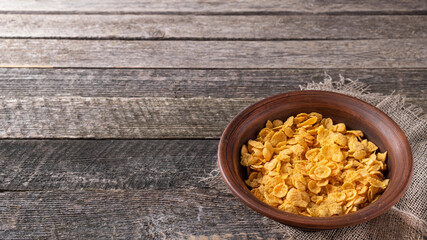 Cornflakes in a bowl  in rustic style with copy space