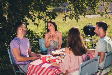 Four nice attractive glad excited best buddy fellow cheerful cheery guys group meeting talking eating lunch spending weekend laughing pastime fresh air sunny day weather having fun