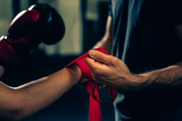close up of trainer puts boxing bandages