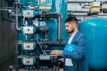 supervisor checking chemical water treatment equipment