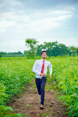 Fototapeta premium Young asian / Indian man running at agriculture field