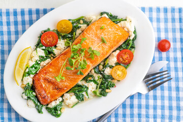 Grilled salmon steak with vegetables and fresh microgreens. Food concept for a ketogenic and no carbohydrate diet.