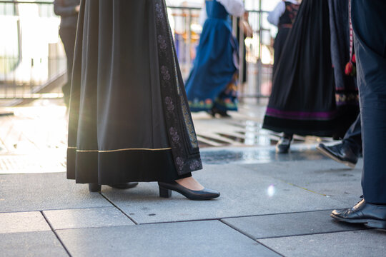 Close up image of elegant female dressed in traditional Norwegian dress Bunad and black pumps.
