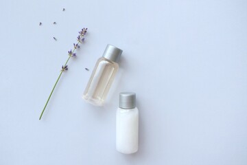Composition with lavender and beauty products for hair and body care on blue background. Organic SPA beauty products. Flat lay, top view. SPA branding mockups.