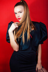 young pretty woman young lady posing on red background wearing gold jewelry, lifestyle people concept