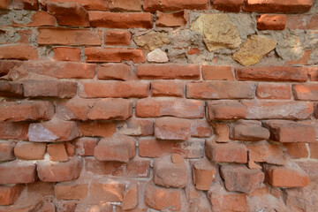 old red brick wall with protruding bricks