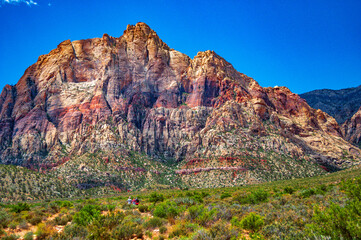 A small group of day hikers follow the trail towards the mountain range at Red Rock Canyon outside Las Vegas NV