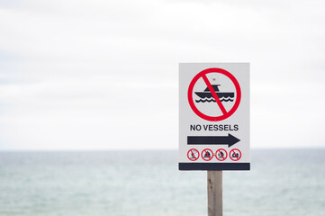 Parking sign "No vessels". Outdoor. Sign stands near the sea.